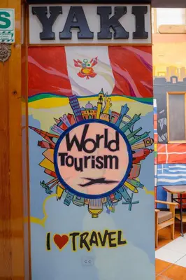 a door with a sign that reads world tourism at Yaki Hostel in Lima