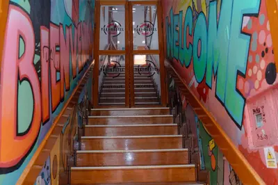 a staircase in a room with graffiti on the walls at Yaki Hostel in Lima
