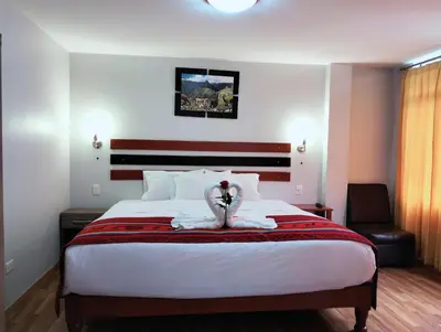 a bedroom with a bed with a stuffed animal on it at Raymi MachuPicchu in Machu Picchu