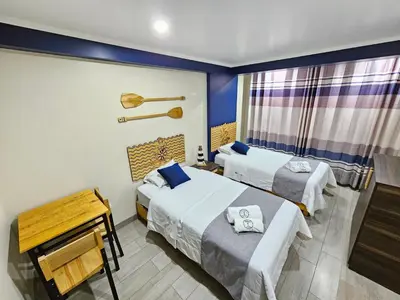 a hotel room with two beds and a window at EL FARO HOTEL in Chala