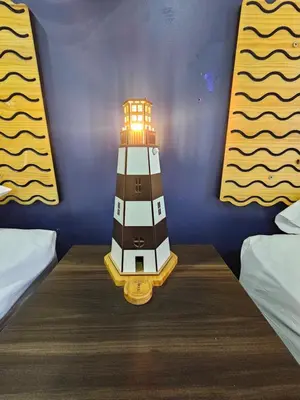 a toy lighthouse sitting on a table in a room at EL FARO HOTEL in Chala