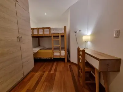 a small room with a desk and a bunk bed at Departamento estreno 2do piso in La Molina