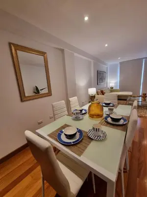a dining room with a white table and chairs at Departamento estreno 2do piso in La Molina