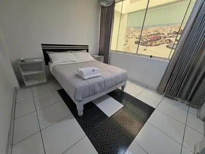 a bedroom with a bed and a large window at Hotel Real San Pedro in El Puente