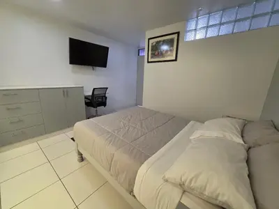 a bedroom with a bed and a flat screen tv at Hotel Real San Pedro in El Puente
