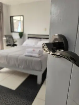 a room with a bed and a door with a door knob at Hotel Real San Pedro in El Puente