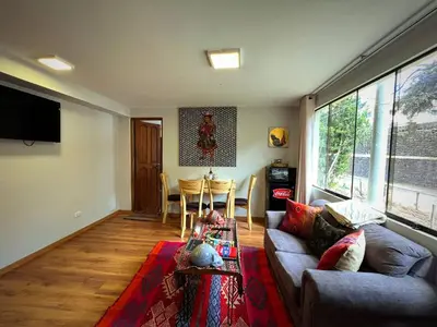 a living room with a couch and a table at Kintu Apartamento cusco in Cusco