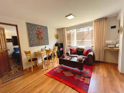 a living room with a couch and a table at Kintu Apartamento cusco in Cusco