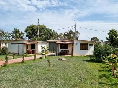 a small white house with a yard at URMA 2 in Barranca