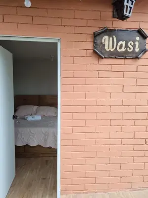 a brick wall with a bed in a room at URMA 2 in Barranca