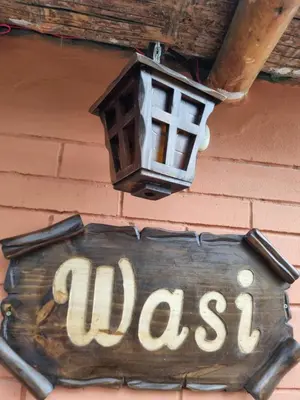 a sign on a building with a street sign and a lamp at URMA 2 in Barranca