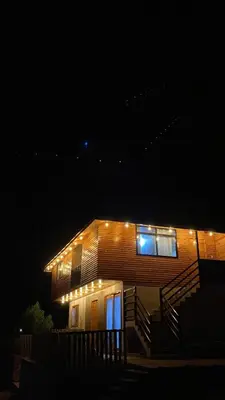 a house with lights on it at night at Carol Haus in Oxapampa