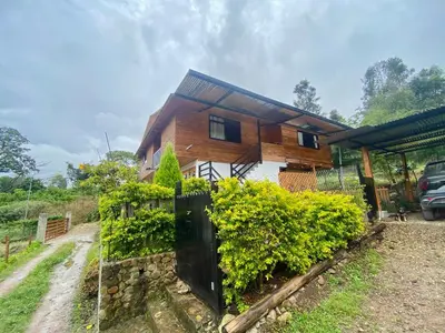 a house with a fence in front of it at Carol Haus in Oxapampa