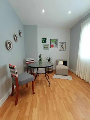 a living room with a table and a chair at Like/Home in Lima