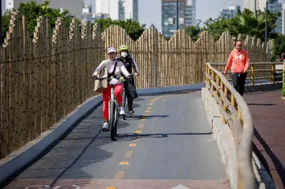 two people riding bikes on a bridge at Like/Home in Lima