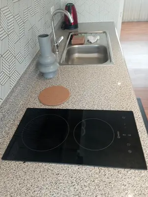 a kitchen counter top with a sink and a sink at Like/Home in Lima