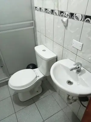 a bathroom with a toilet and a sink at Hospedaje Apu Salka in Cusco