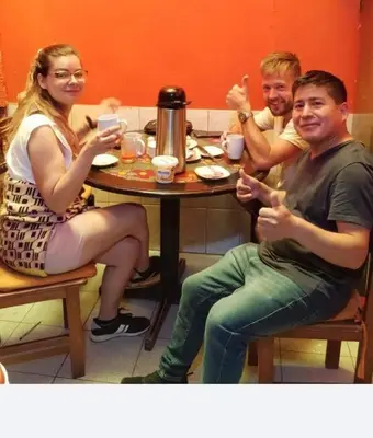 a group of people sitting around a table at Hospedaje Apu Salka in Cusco