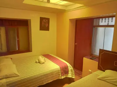 a bedroom with a bed with a stuffed animal on it at Hospedaje Apu Salka in Cusco