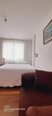 a bedroom with a large bed and a couch at HOSPEDAJE TURISTICO CHORRILLOS Sueños de Luna INN in Lima