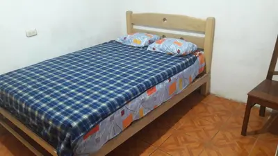 a bed with two pillows on it in a room at Hospedaje D'LEYDI in Lima