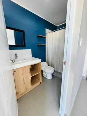 a bathroom with a white toilet and a sink at Almar Punta Hermosa in Punta Hermosa