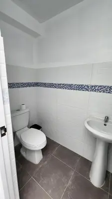 a bathroom with a toilet and a sink at Casa de Playa en Cerro Azul in Cerro Azul