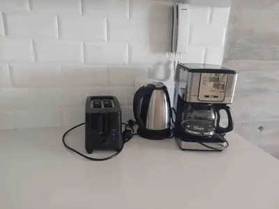 a kitchen counter with a coffee maker and a toaster at 3BR Paracas Kite Gym Work Oasis in Santo Domingo