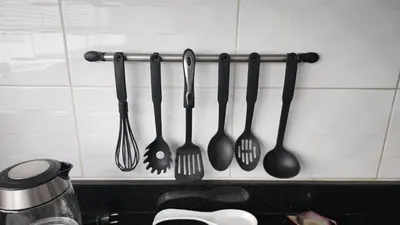 a group of utensils hanging on a kitchen wall at New! Modern 4BR Apartment Miraflores Lima in Lima
