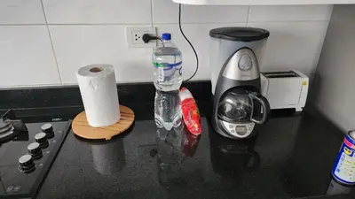 a counter top with a bottle of water and a blender at New! Modern 4BR Apartment Miraflores Lima in Lima