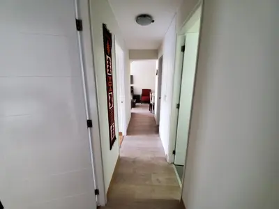 a hallway with white walls and a long corridor at New! Modern 4BR Apartment Miraflores Lima in Lima
