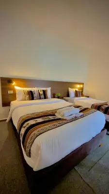 a row of beds in a hotel room at Andean Palace Boutique in Cusco