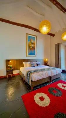 a bedroom with a large bed and a red rug at Andean Palace Boutique in Cusco