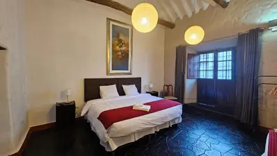 a bedroom with a large bed and two lights at Andean Palace Boutique in Cusco