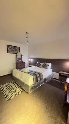 a bedroom with a large bed and a desk at Andean Palace Boutique in Cusco