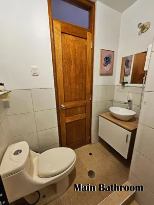 a bathroom with a toilet and a sink at Puma Wasi, céntrico, acogedor, bien iluminado in Cusco