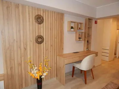 a room with a desk and a vase of flowers at Loft de estreno, San Borja, muy centrico in Lima