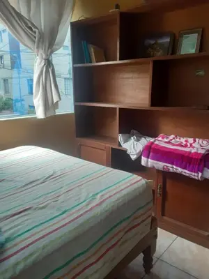 a bedroom with a bed and a book shelf at ALAVA 245 in Lima
