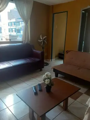 a living room with a couch and a coffee table at ALAVA 245 in Lima