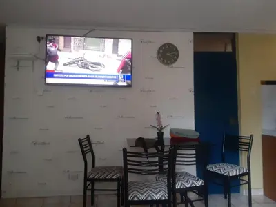 a room with three chairs and a tv on a wall at ALAVA 245 in Lima
