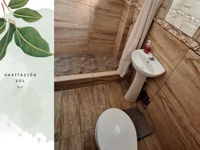 a bathroom with a toilet and a sink at Casa Vacacional Puro Jita in Lunahuaná