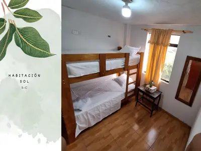 a bedroom with two bunk beds and a window at Casa Vacacional Puro Jita in Lunahuaná