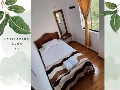 a bedroom with a bed and a window at Casa Vacacional Puro Jita in Lunahuaná