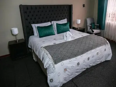 a bedroom with a large bed with two stuffed animals on it at Blub Hotel Spa in Huancayo