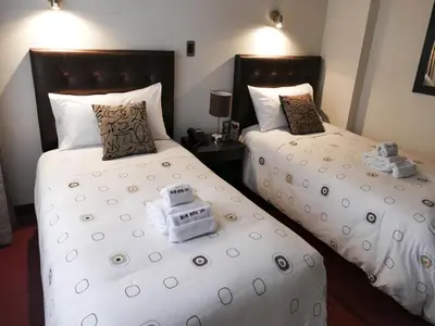 two beds with teddy bears on them in a room at Blub Hotel Spa in Huancayo