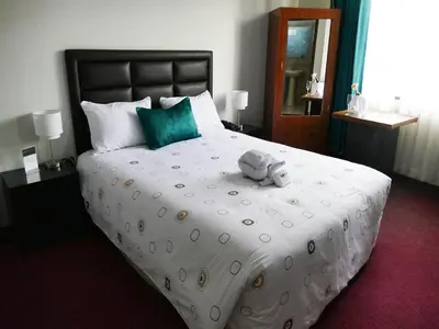 a bedroom with a large bed with a stuffed animal on it at Blub Hotel Spa in Huancayo