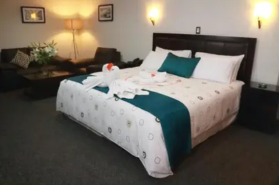 a hotel room with a large bed with towels on it at Blub Hotel Spa in Huancayo