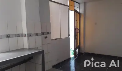 a room with a kitchen with a counter and a window at Peruvian Apartment in Lima