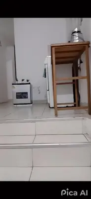 a kitchen with a table and a microwave and a table at Peruvian Apartment in Lima