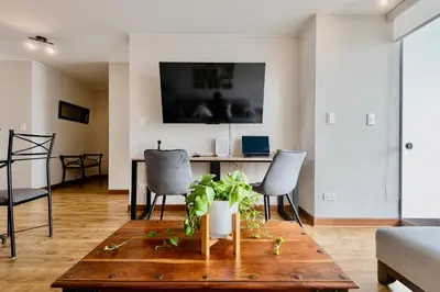 a living room with a table and chairs at ALU Apartments - Miraflores Boardwalk, Wifi 70M in Lima